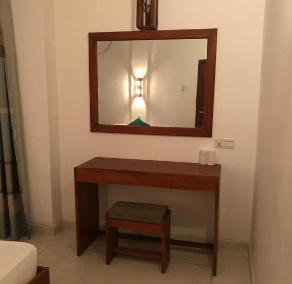 Quarto Deluxe Cama King, Bienvenido Cozy Madiha